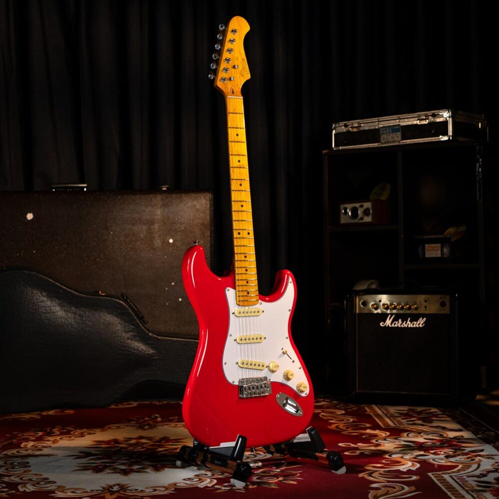 Gusta GST-01 Vintage SSS a red and white electric guitar on a red carpet